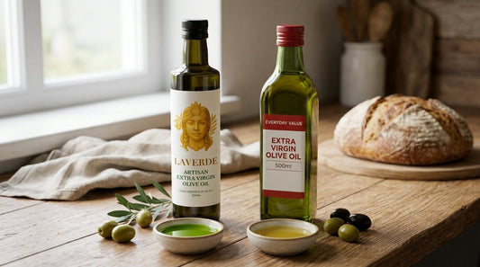 Single-estate Italian olive oil bottle on a wooden surface — UK 2026 buyer's comparison of regional origin vs single-estate EVOO premium